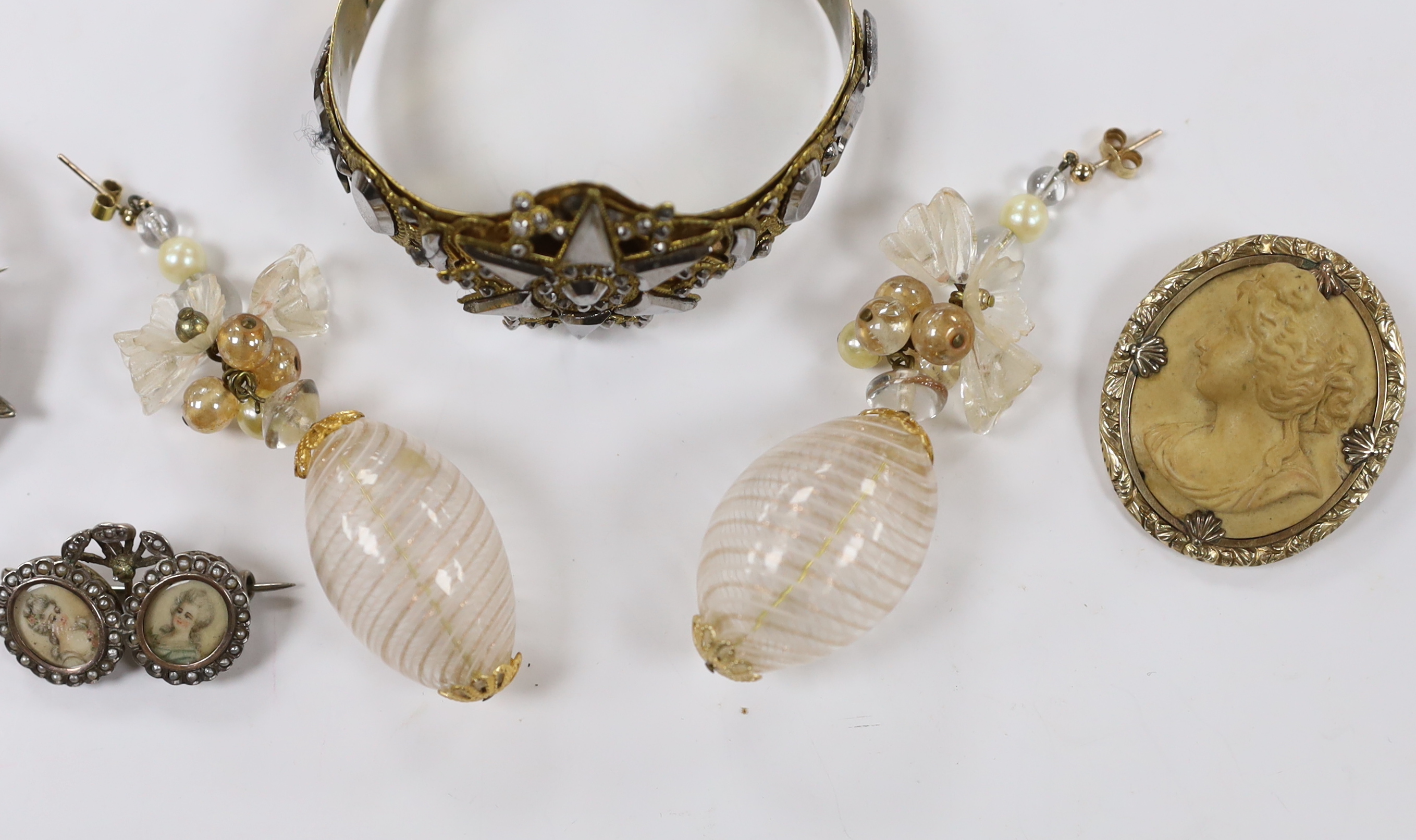 A small collection of assorted jewellery including a lava brooch, Scottish hardstone and cabochon set white metal brooch, pair of Venetian? glass drop earrings, two tone cut steel bangle and a white metal and simulated s
